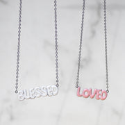 Faith-inspired necklaces from AMADI Jewelry’s ‘He Says That I Am’ collection. Identity in Christ jewelry for Christian women, inspired by Ephesians 1:3-13. Gold-plated and enamel pendants.