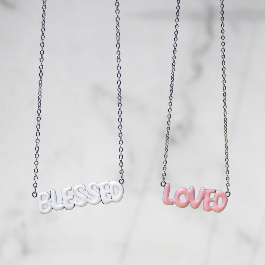 Faith-inspired necklaces from AMADI Jewelry’s ‘He Says That I Am’ collection. Identity in Christ jewelry for Christian women, inspired by Ephesians 1:3-13. Gold-plated and enamel pendants.